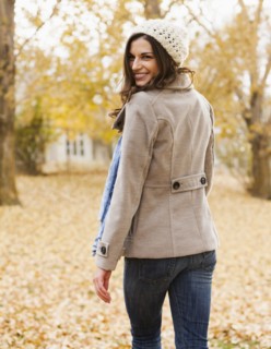 Caucasian woman walking in autumn leaves
