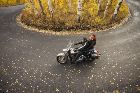 Caucasian couple riding motorcycle