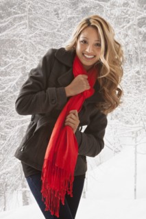 Mixed race woman smiling in snow