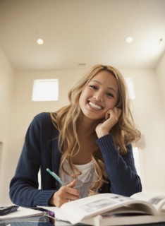 Smiling mixed race woman studying