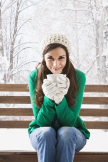 Caucasian woman having cup of coffee in snow