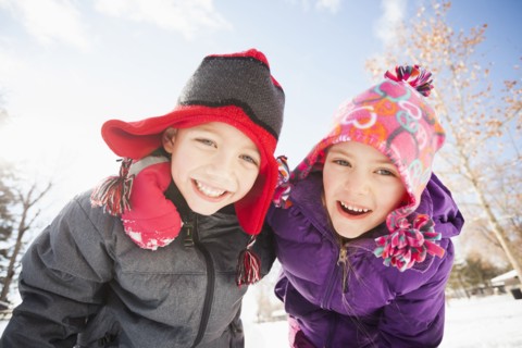 Caucasian children smiling in snow