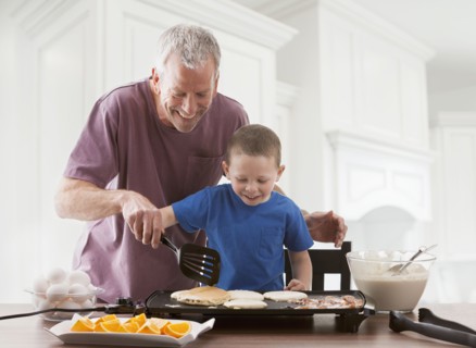 Caucasian father and son cooking breakfast