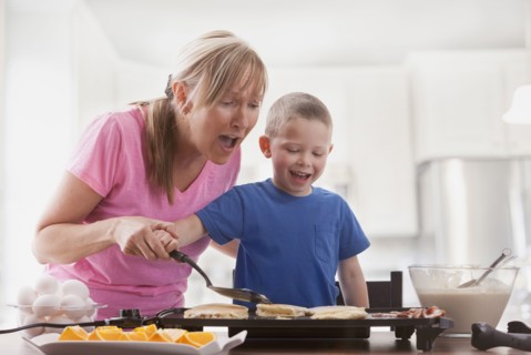 Caucasian mother and son cooking breakfast
