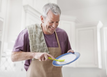 Caucasian man washing dishes in kitchen