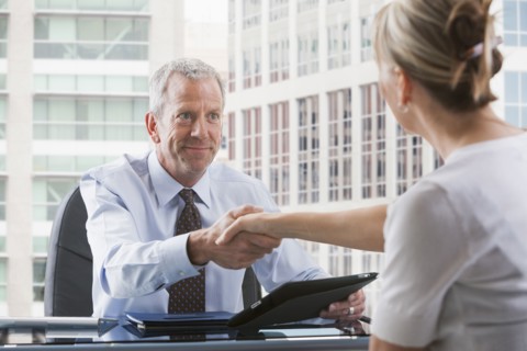 Caucasian businessman shaking hands with client