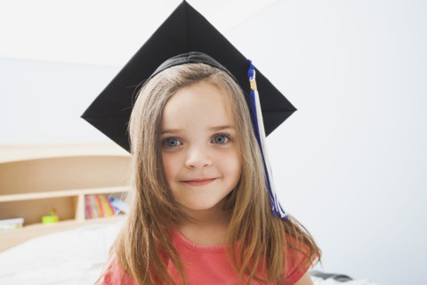 Caucasian girl wearing graduate cap