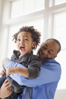 Father and son playing indoors