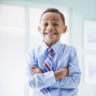 Mixed race boy wearing shirt and tie