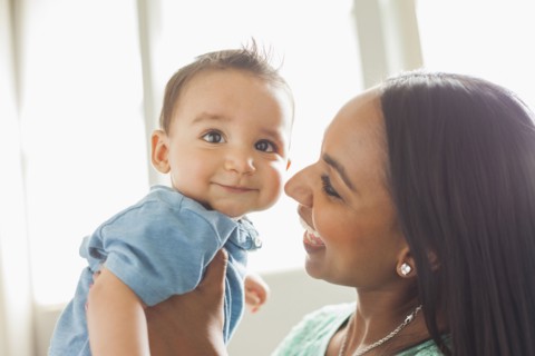 Smiling mother holding son