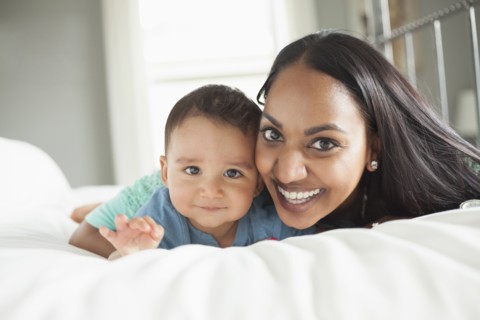 Mother and son laying on bed