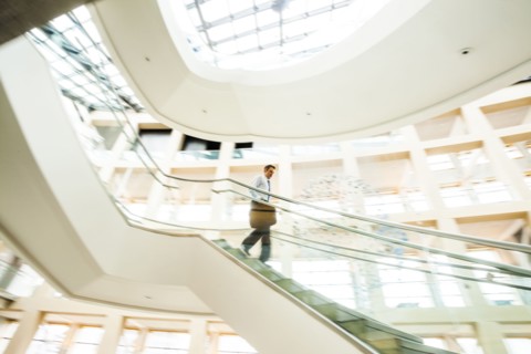 Caucasian businessman rushing on office staircase
