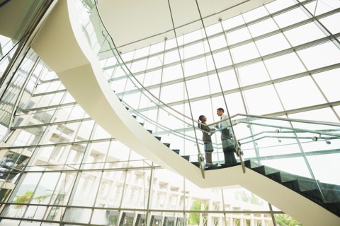 Business people talking on office staircase