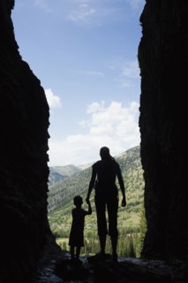 Caucasian mother and son exploring cave