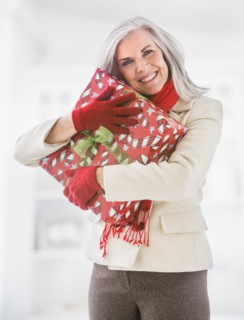 Portrait of Caucasian woman hugging Christmas gift
