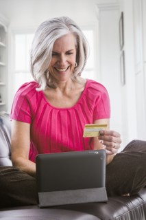 Smiling Caucasian woman shopping online