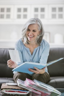 Smiling Caucasian woman looking at photograph albums