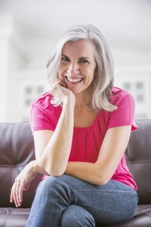 Portrait of smiling Caucasian woman on sofa
