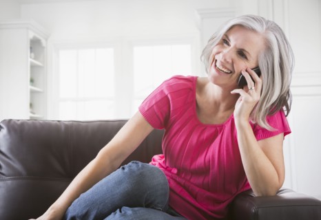 Happy Caucasian woman talking on cell phone