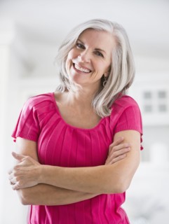 Portrait of smiling Caucasian woman with arms crossed