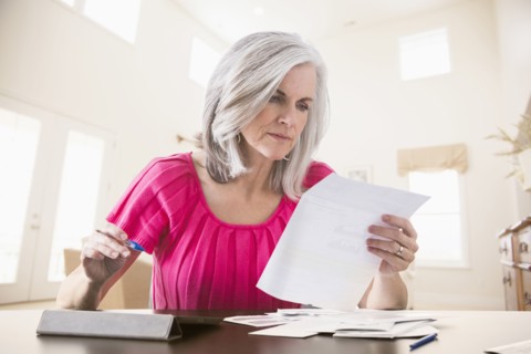Caucasian woman paying bills online