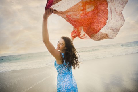 Caucasian woman playing on beach