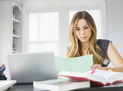 Mixed race woman studying at home