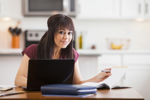 Hispanic businesswoman working at home