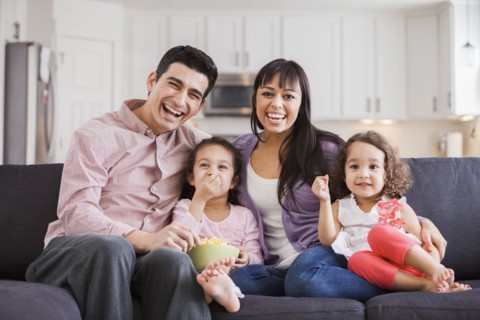Family smiling together on sofa
