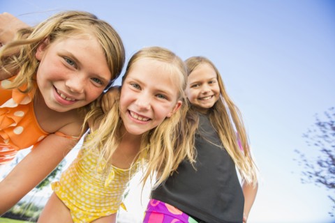 Low angle view of Caucasian girls smiling outdoors