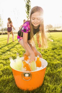 Caucasian girl drinking soda in backyard