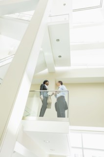 Low angle view of business people talking on office balcony