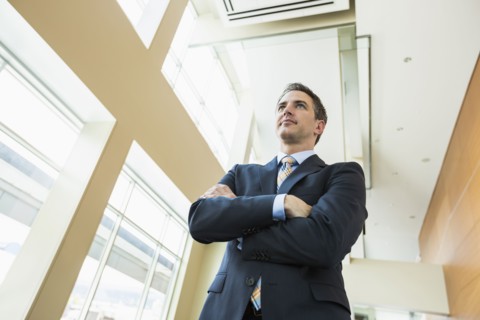 Low angle view of Caucasian businessman standing in office