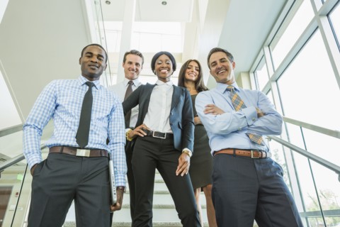 Low angle view of business people smiling on office staircase