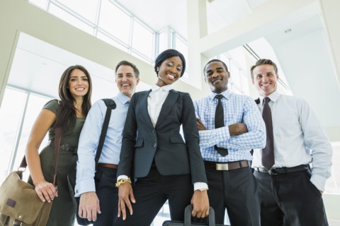 Low angle view of business people smiling in office lobby