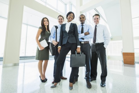 Business people smiling in office lobby