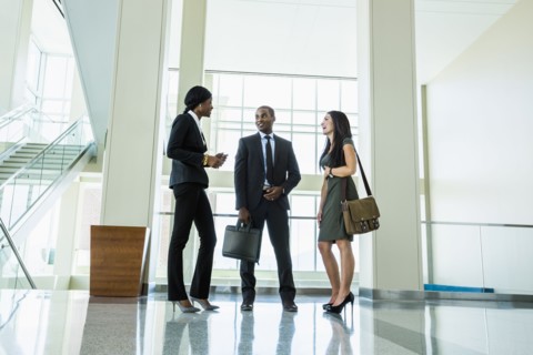 Business people talking in office hallway