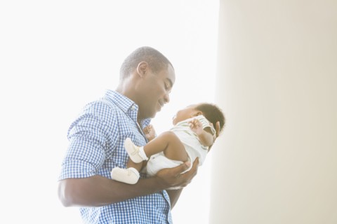 Father cradling baby son