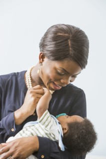 Mother cradling baby son