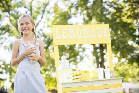 Caucasian girl smiling at lemonade stand