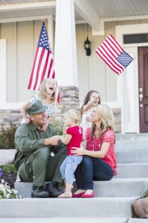 Caucasian soldier and family playing together on front stoop