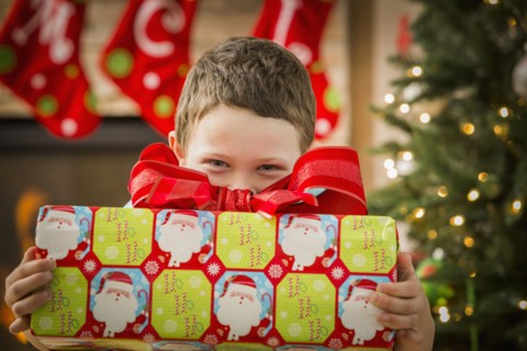 Caucasian boy holding Christmas gift