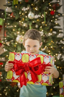 Caucasian boy holding Christmas gift