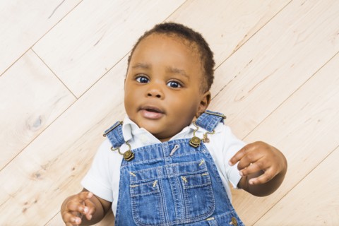 Black baby boy laying on floor