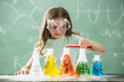 Caucasian girl doing science experiment in classroom