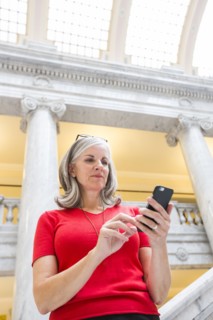 Caucasian businesswoman using cell phone in courthouse