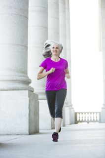 Caucasian woman jogging outside courthouse