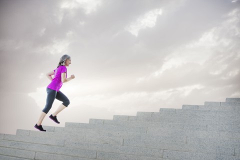 Caucasian woman jogging on steps