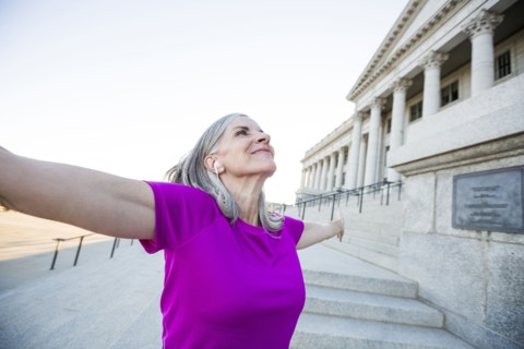 Caucasian woman standing outside courthouse