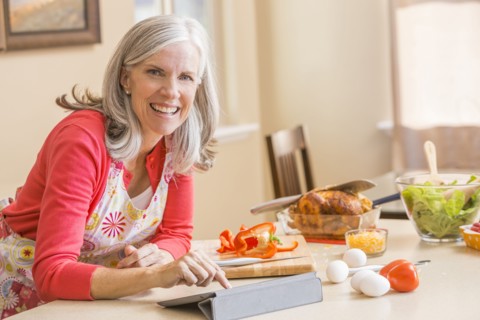 Caucasian woman cooking in kitchen